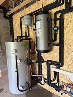 Indoor air source heat pump plant room installation with pipework