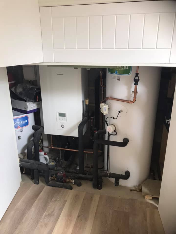 Indoor air source heat pump plant room installation with pipework